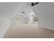 Bright bonus room with neutral carpet, ceiling fans, and multiple windows offering natural light at 120 Firefly Ln, Louisburg, NC 27549