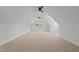 A finished bonus room with neutral carpet and windows at 120 Firefly Ln, Louisburg, NC 27549