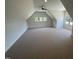 Spacious finished bonus room with vaulted ceilings, large windows, recessed lighting and new carpet at 120 Firefly Ln, Louisburg, NC 27549