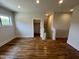 Upstairs bonus room features hardwood flooring, bright window and an extra storage closet by the stairway at 120 Firefly Ln, Louisburg, NC 27549