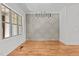 Elegant dining room with hardwood floors, decorative wall paneling, and modern chandelier lighting at 120 Firefly Ln, Louisburg, NC 27549