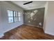 Dining room with decorative wall and wood floors, bathed in natural light from a large window at 120 Firefly Ln, Louisburg, NC 27549