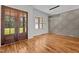 Elegant dining room with hardwood floors, decorative wall paneling, and modern chandelier lighting at 120 Firefly Ln, Louisburg, NC 27549