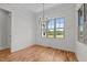 Bright dining room features wood floors, white trim, wainscotting, and windows with views of the landscape at 120 Firefly Ln, Louisburg, NC 27549