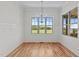 Bright dining room features wood floors, white trim, wainscotting, and windows with views of the landscape at 120 Firefly Ln, Louisburg, NC 27549