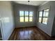 Elegant dining room with wainscoting, wood floors, and lots of natural light from two large windows at 120 Firefly Ln, Louisburg, NC 27549