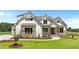 Charming two-story home features board and batten siding and stone accents, set on a well-manicured lawn at 120 Firefly Ln, Louisburg, NC 27549