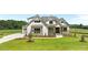 Charming two-story home features board and batten siding and stone accents, set on a well-manicured lawn at 120 Firefly Ln, Louisburg, NC 27549