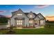 Charming two-story home features board and batten siding and stone accents, set on a well-manicured lawn at 120 Firefly Ln, Louisburg, NC 27549