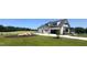 Beautiful modern farmhouse with landscaped front yard and spacious three-car garage at 120 Firefly Ln, Louisburg, NC 27549