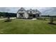 Beautiful two-story home with manicured lawn and elegant stone accents at 120 Firefly Ln, Louisburg, NC 27549