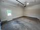 Clean two-car garage with concrete flooring, white door, and light trim at 120 Firefly Ln, Louisburg, NC 27549