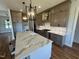 Gourmet kitchen featuring an oversized island, custom cabinets, and stainless steel appliances at 120 Firefly Ln, Louisburg, NC 27549