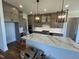 Spacious kitchen featuring a large island, custom cabinets, and stainless steel appliances at 120 Firefly Ln, Louisburg, NC 27549