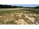 A parcel of cleared land for sale is near a tree line and fields in the distance at 120 Firefly Ln, Louisburg, NC 27549