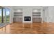 Living room boasts hardwood floors, fireplace with built-ins, and natural light at 120 Firefly Ln, Louisburg, NC 27549