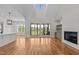 Spacious living room with hardwood floors, fireplace, built-ins, and sliding doors to the outdoor deck at 120 Firefly Ln, Louisburg, NC 27549