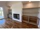 Open concept living room with fireplace, custom built ins, and access to a backyard deck at 120 Firefly Ln, Louisburg, NC 27549
