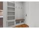 Mudroom with built-in bench, shelving, and coat hooks, adjacent to an entry door at 120 Firefly Ln, Louisburg, NC 27549