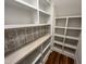 Walk-in pantry features custom shelving, beautiful tile backsplash, countertop space, and ample storage at 120 Firefly Ln, Louisburg, NC 27549
