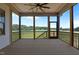 Covered porch features a ceiling fan and panoramic views of the open fields at 120 Firefly Ln, Louisburg, NC 27549
