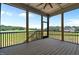 Inviting screened porch with a ceiling fan and picturesque views of the surrounding landscape at 120 Firefly Ln, Louisburg, NC 27549