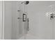 Close up of a tiled shower with glass shelving and modern fixtures, including a handheld sprayer at 120 Firefly Ln, Louisburg, NC 27549