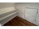 Bright storage area features natural wood flooring, white shelves, and small door access at 120 Firefly Ln, Louisburg, NC 27549