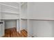 A closet with open shelving and wooden rods and a wood floor at 120 Firefly Ln, Louisburg, NC 27549