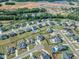 An aerial of a new home community with manicured lawns, mature trees, and construction in progress nearby at 121 Nate Ct, Wake Forest, NC 27587