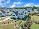 Aerial shot showcases a white modern home with a black roof, front yard landscaping, and well-maintained lawns at 121 Nate Ct, Wake Forest, NC 27587
