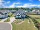 Aerial view of a modern home with a driveway, landscaping, and manicured lawn in a suburban neighborhood at 121 Nate Ct, Wake Forest, NC 27587