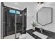 Modern bathroom featuring a stylish black-tiled shower and unique hexagon mirror at 121 Nate Ct, Wake Forest, NC 27587