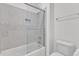 Modern bathroom featuring tile tub surround, glass shower door, and neutral color palette at 121 Nate Ct, Wake Forest, NC 27587