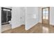 Hallway view to a modern bathroom with black and white tiling and glass shower at 121 Nate Ct, Wake Forest, NC 27587