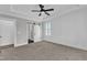 Spacious bedroom with modern ceiling fan and access to ensuite bathroom and closet via sliding barn door at 121 Nate Ct, Wake Forest, NC 27587