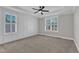 Bright bedroom with a ceiling fan, paneled accent wall, and two windows with plantation shutters at 121 Nate Ct, Wake Forest, NC 27587