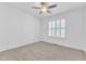 Bright bedroom with ceiling fan, plush carpet, and window with white shutters at 121 Nate Ct, Wake Forest, NC 27587
