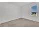 Bright bedroom with neutral carpet, large window overlooking the outdoors, and white trim at 121 Nate Ct, Wake Forest, NC 27587