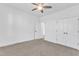 Bright, carpeted bedroom features a ceiling fan, closet, and white painted trim at 121 Nate Ct, Wake Forest, NC 27587