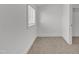 Small bedroom features neutral carpet, large window overlooking the outdoors, and white trim at 121 Nate Ct, Wake Forest, NC 27587
