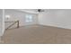 A versatile bonus room with neutral carpeting, ceiling fan, and natural light at 121 Nate Ct, Wake Forest, NC 27587