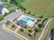 Aerial view of the community pool with a pool house, parking, and surrounding green spaces at 121 Nate Ct, Wake Forest, NC 27587