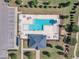Top-down perspective of a pristine community pool, complete with lounge chairs, shaded areas, and a parking lot at 121 Nate Ct, Wake Forest, NC 27587