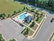 Aerial shot of the community pool area, boasting ample seating, a pool house, and lush landscaping at 121 Nate Ct, Wake Forest, NC 27587
