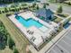 Community pool featuring a slide, lounge chairs, and covered seating, all surrounded by well-manicured landscaping at 121 Nate Ct, Wake Forest, NC 27587