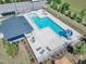 Overhead view of a community pool with plenty of lounge chairs, a slide, and an adjacent clubhouse at 121 Nate Ct, Wake Forest, NC 27587
