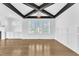 Dining room features hardwood flooring, wainscoting, and decorative ceiling beams at 121 Nate Ct, Wake Forest, NC 27587