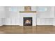 Close-up of the living room fireplace with built-in cabinets and hardwood floors at 121 Nate Ct, Wake Forest, NC 27587