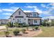 Beautiful two-story modern farmhouse with a landscaped yard and a stone-lined garden at 121 Nate Ct, Wake Forest, NC 27587
